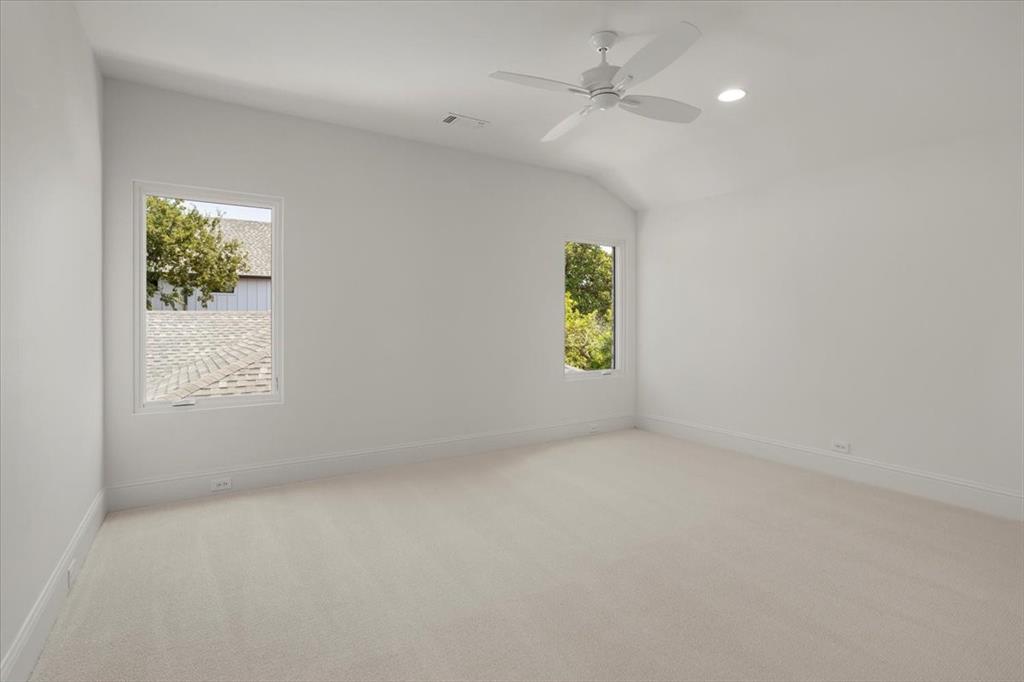 3935 Rochelle Drive Dallas, TX 75220 - Photo 22 of 27 an empty room with windows and ceiling fan