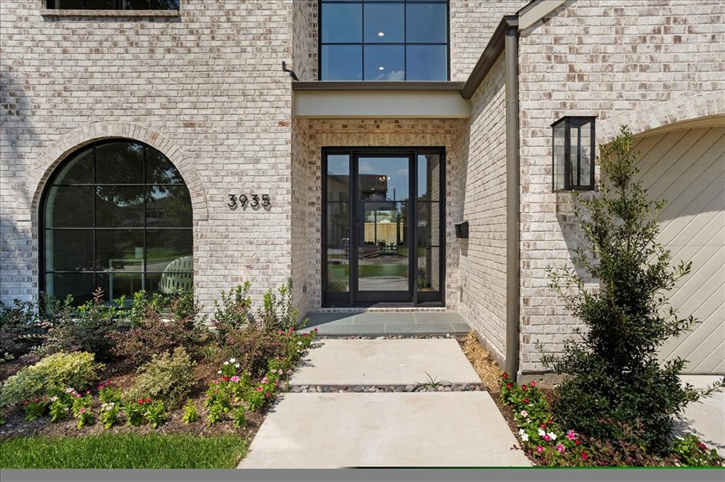 3935 Rochelle Drive Dallas, TX 75220 - Photo 4 of 27 a stone house with potted plants in front of door