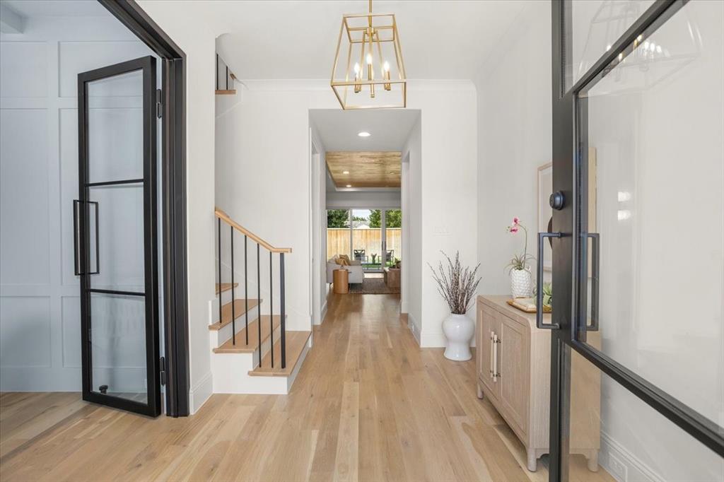 3935 Rochelle Drive Dallas, TX 75220 - Photo 5 of 27 a view of a hallway with wooden floor and staircase
