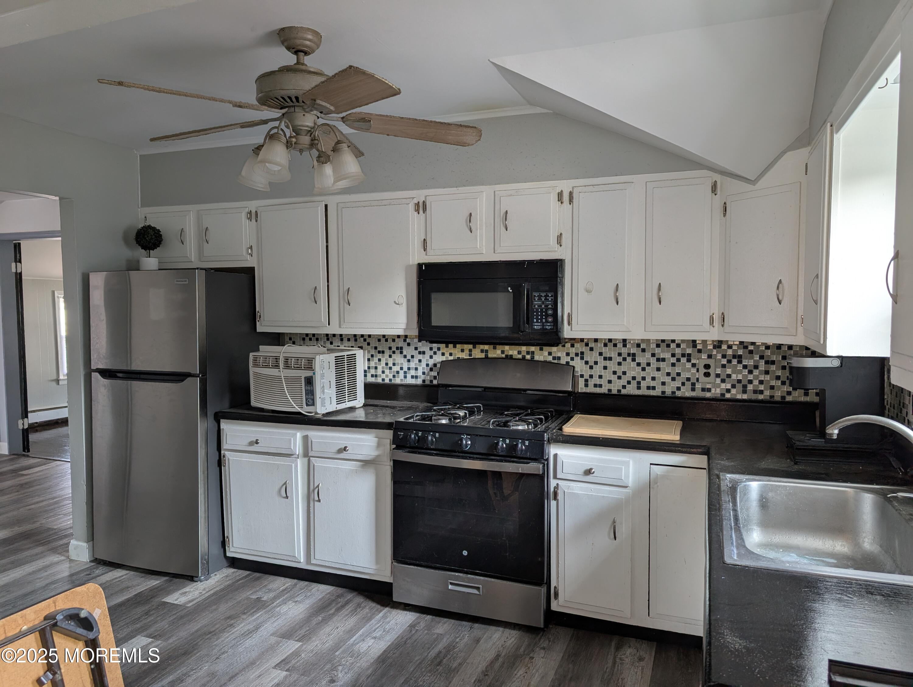 164 Port Monmouth Road, Unit B Keansburg, NJ 07734 - Photo 1 of 17 a kitchen with stainless steel appliances a stove a sink and a refrigerator