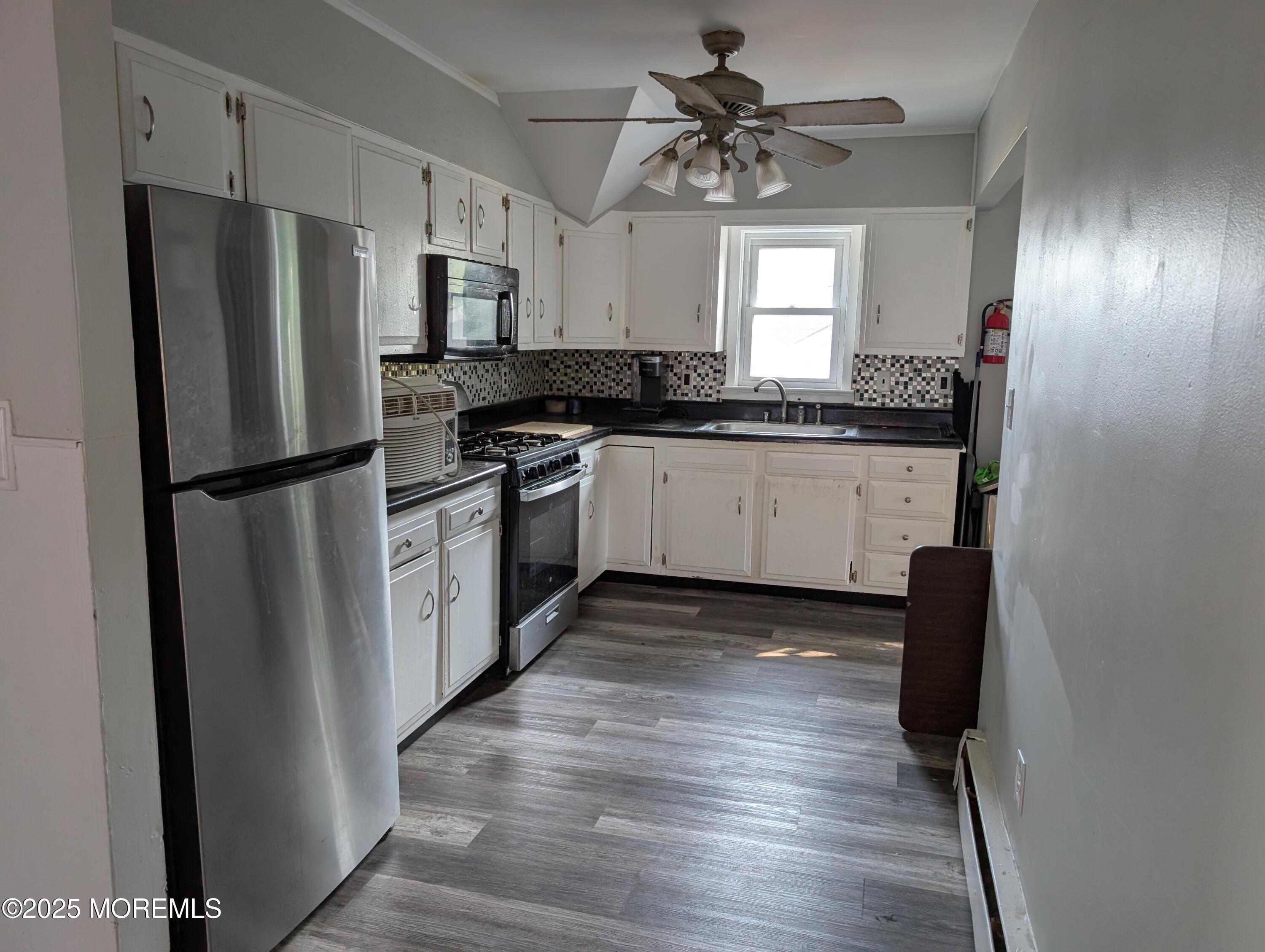 164 Port Monmouth Road, Unit B Keansburg, NJ 07734 - Photo 12 of 17 a kitchen with granite countertop stainless steel appliances a refrigerator a sink a stove a microwave and cabinets