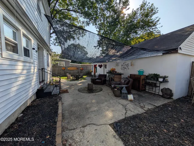 a view of a chairs and tables in the back yard of the house
