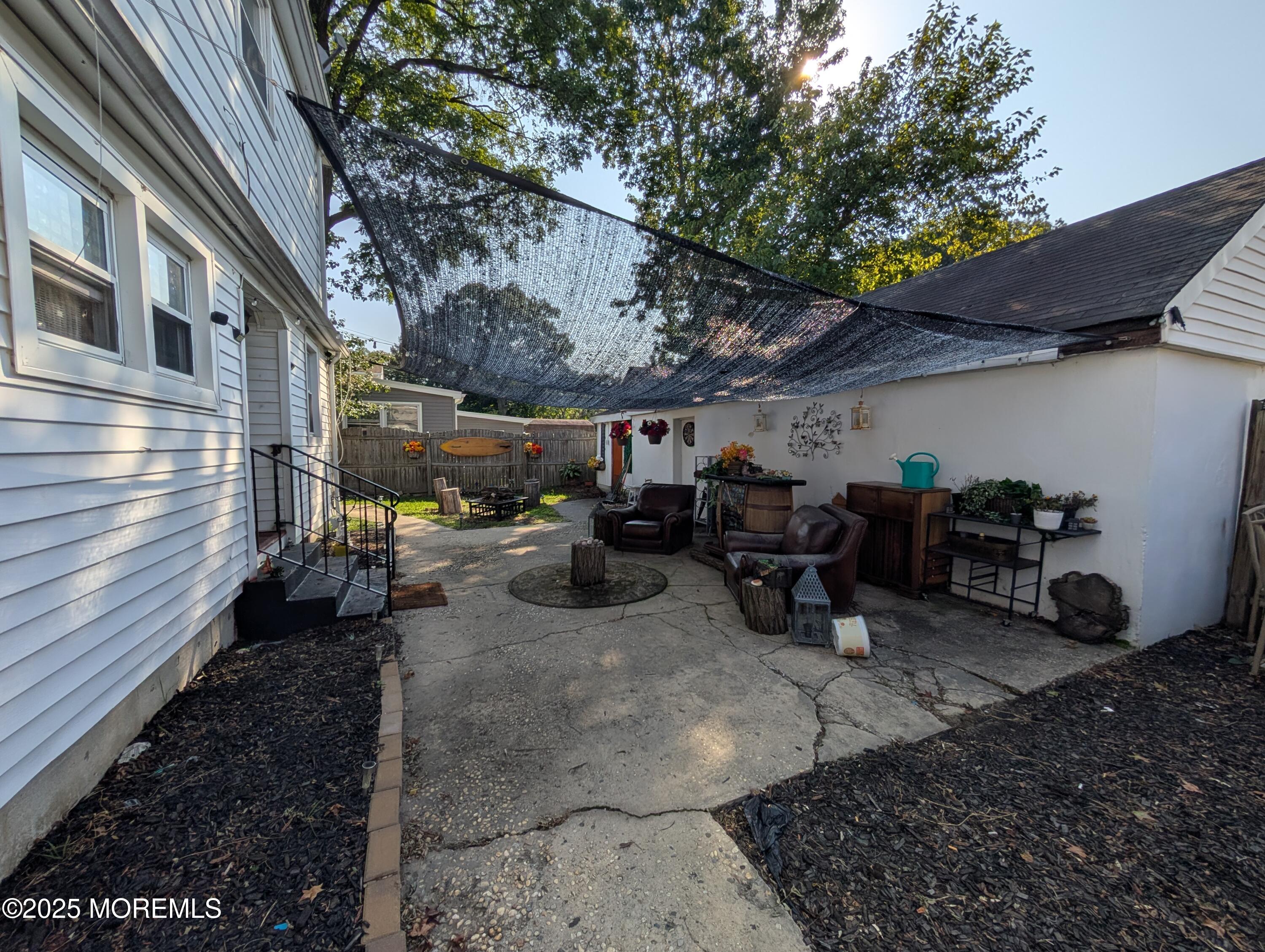 164 Port Monmouth Road, Unit B Keansburg, NJ 07734 - Photo 16 of 17 a view of a chairs and tables in the back yard of the house