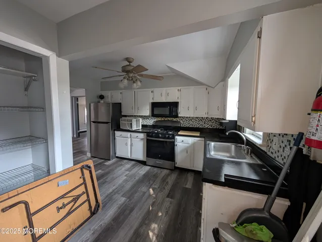 a kitchen with granite countertop a stove and a refrigerator