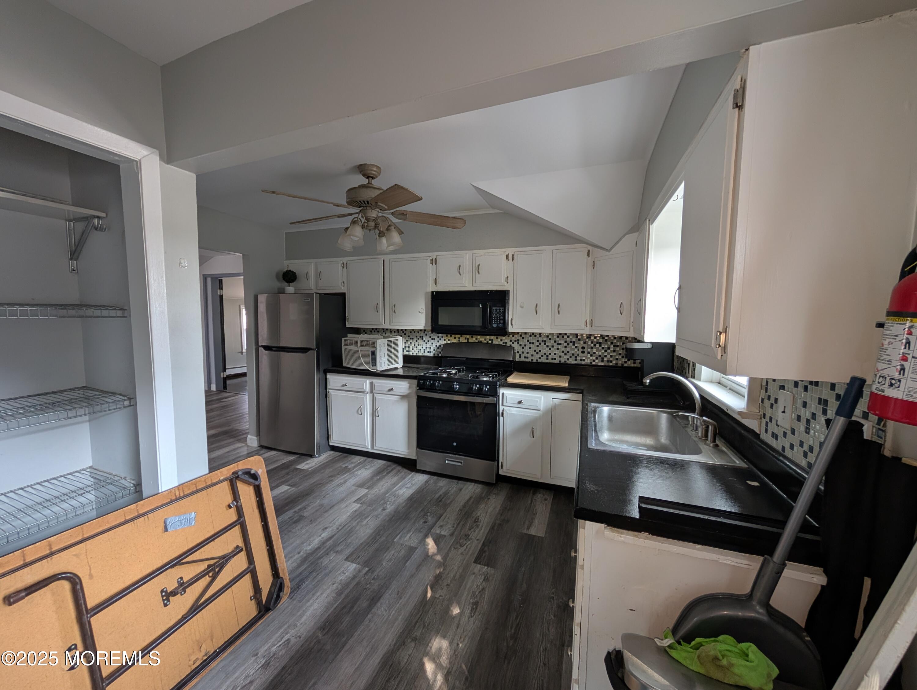 164 Port Monmouth Road, Unit B Keansburg, NJ 07734 - Photo 3 of 17 a kitchen with granite countertop a stove and a refrigerator