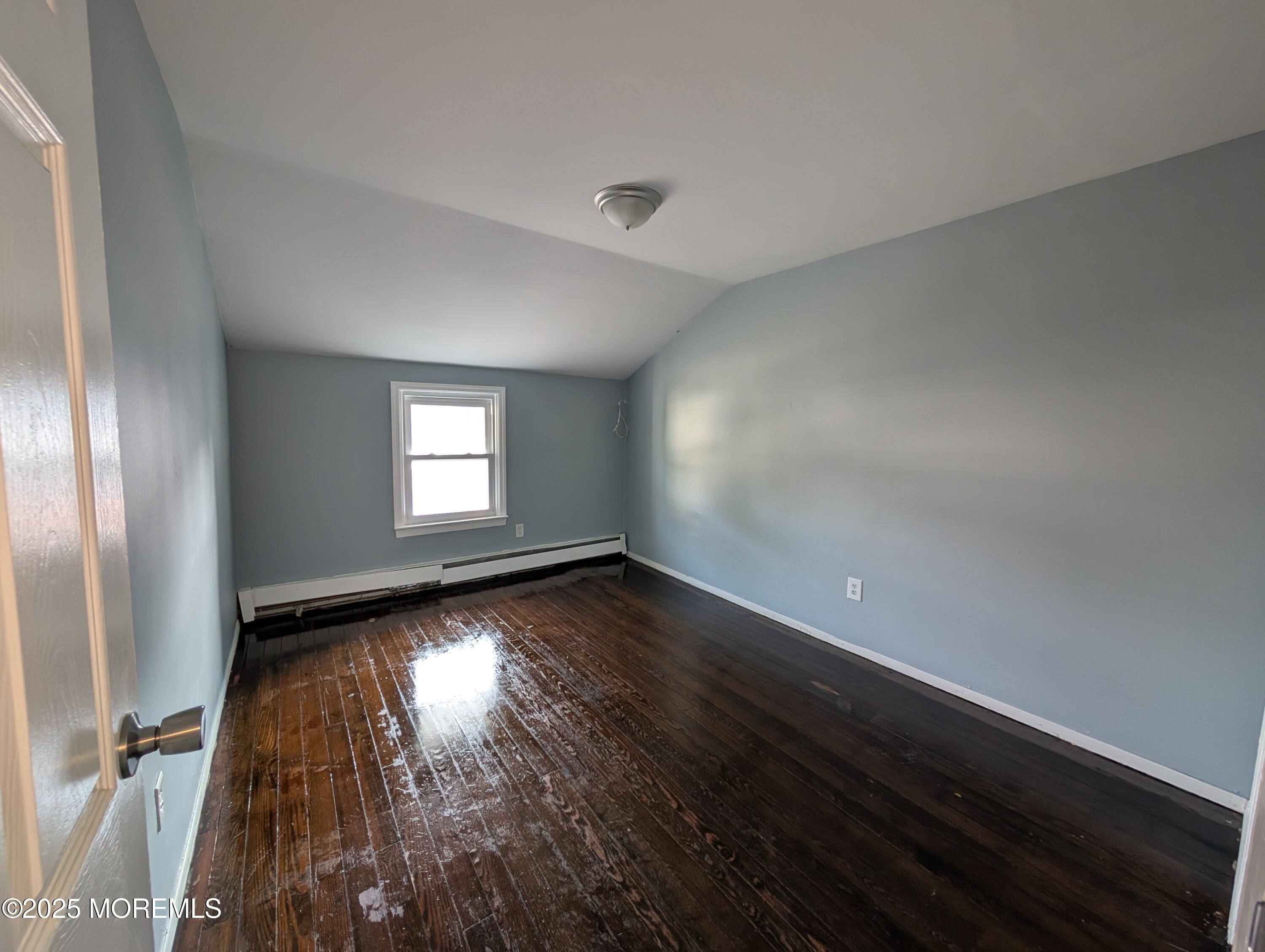 164 Port Monmouth Road, Unit B Keansburg, NJ 07734 - Photo 9 of 17 an empty room with wooden floor and windows