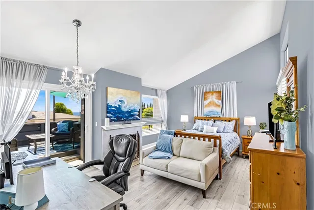 a living room with furniture a chandelier and a flat screen tv