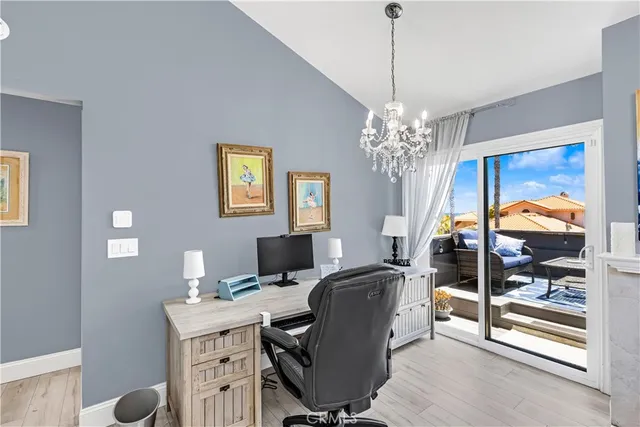 a view of a workspace with furniture and chandelier