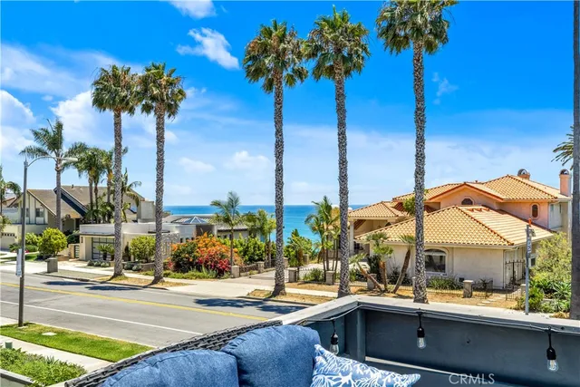a view of a palm tree with a table and chairs