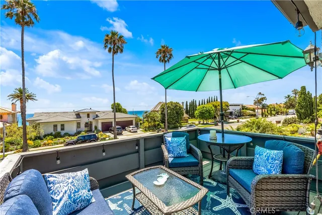 an outdoor space with furniture and umbrella