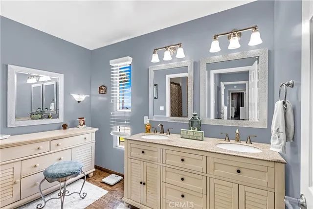 a bathroom with double sink and a mirror