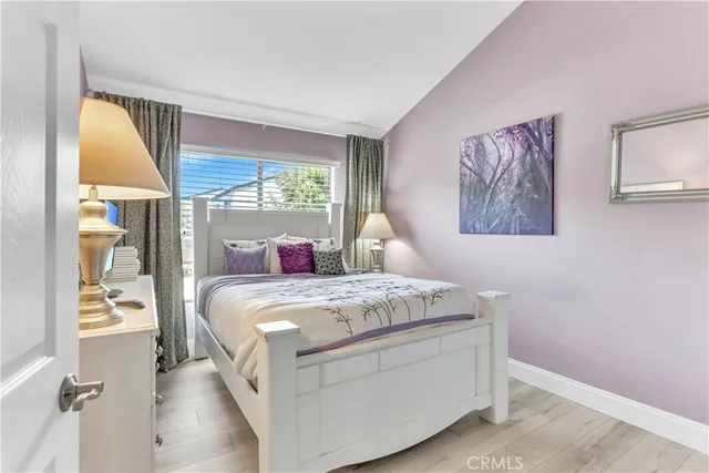 a bed sitting in a bedroom next to a window