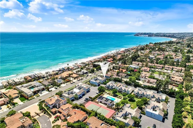an aerial view of residential building and ocean