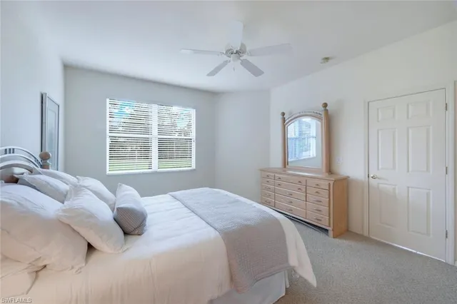 a bedroom with a bed a window and closet