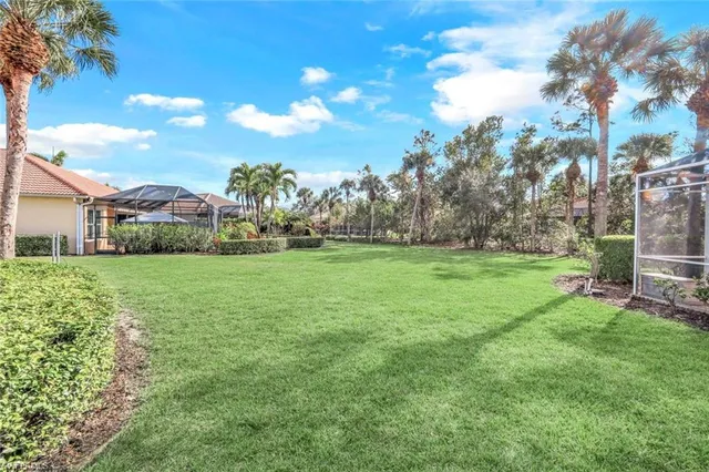 a patio with yard glass top table and chairs