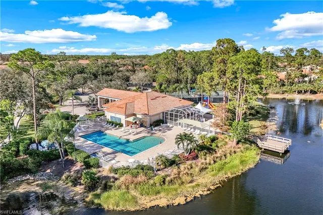 a view of a tennis ground with large trees