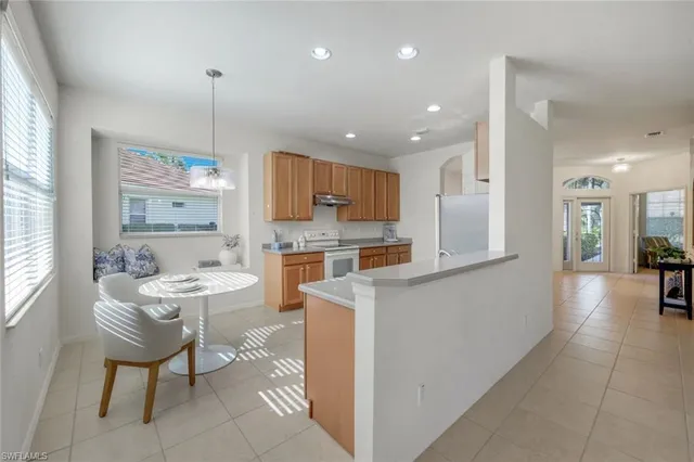 a kitchen with stainless steel appliances granite countertop a sink stove and cabinets
