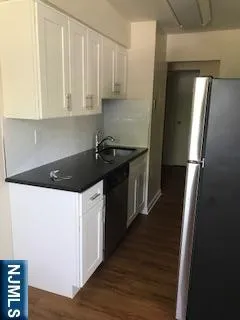 a kitchen with a refrigerator and a stove