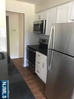 a kitchen with a refrigerator and a stove