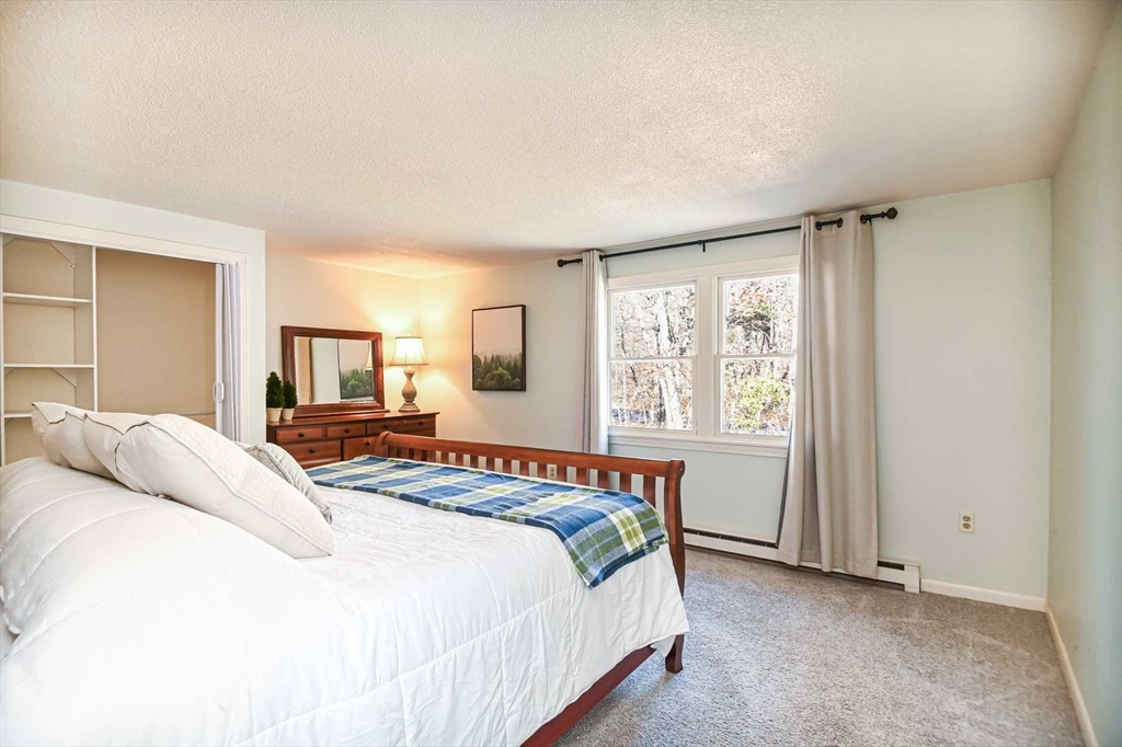 1 Acadia Kimball Road, Unit 1 Amesbury, MA 01913 - Photo 14 of 21 a bedroom with a large bed and a window