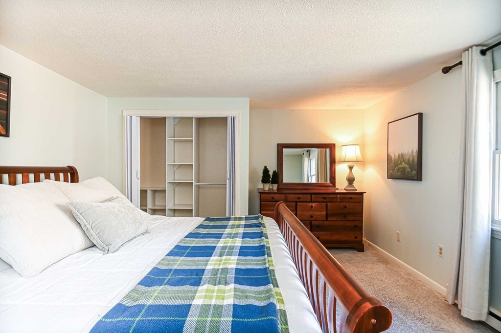 1 Acadia Kimball Road, Unit 1 Amesbury, MA 01913 - Photo 15 of 21 a bedroom with a bed and a dresser