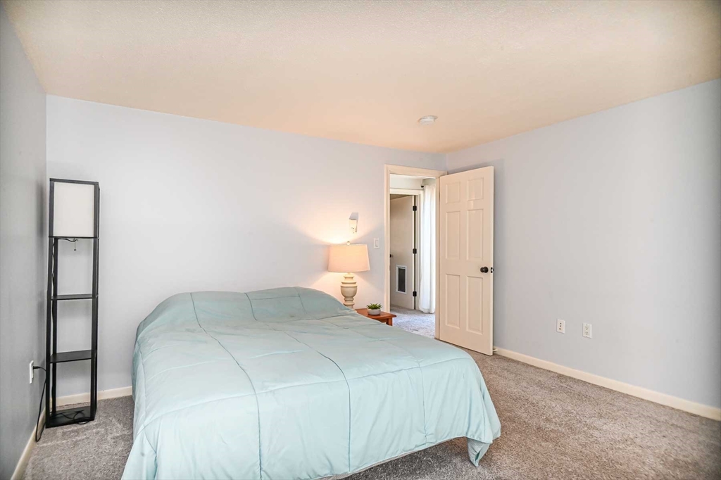 1 Acadia Kimball Road, Unit 1 Amesbury, MA 01913 - Photo 16 of 21 a bedroom with a bed and a night lamp