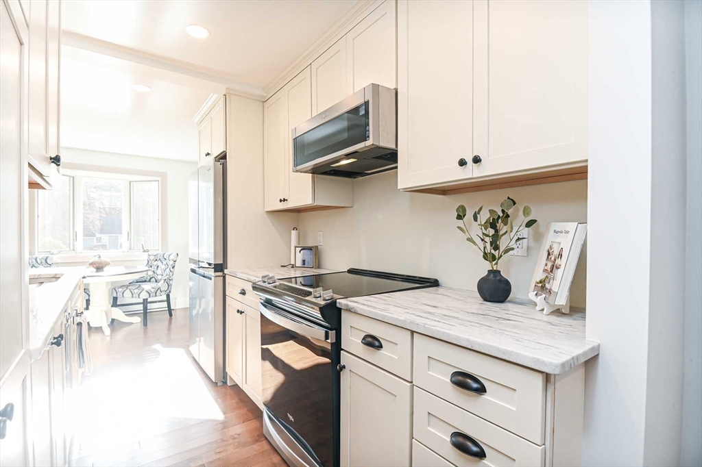 1 Acadia Kimball Road, Unit 1 Amesbury, MA 01913 - Photo 4 of 21 a kitchen with appliances cabinets and a table