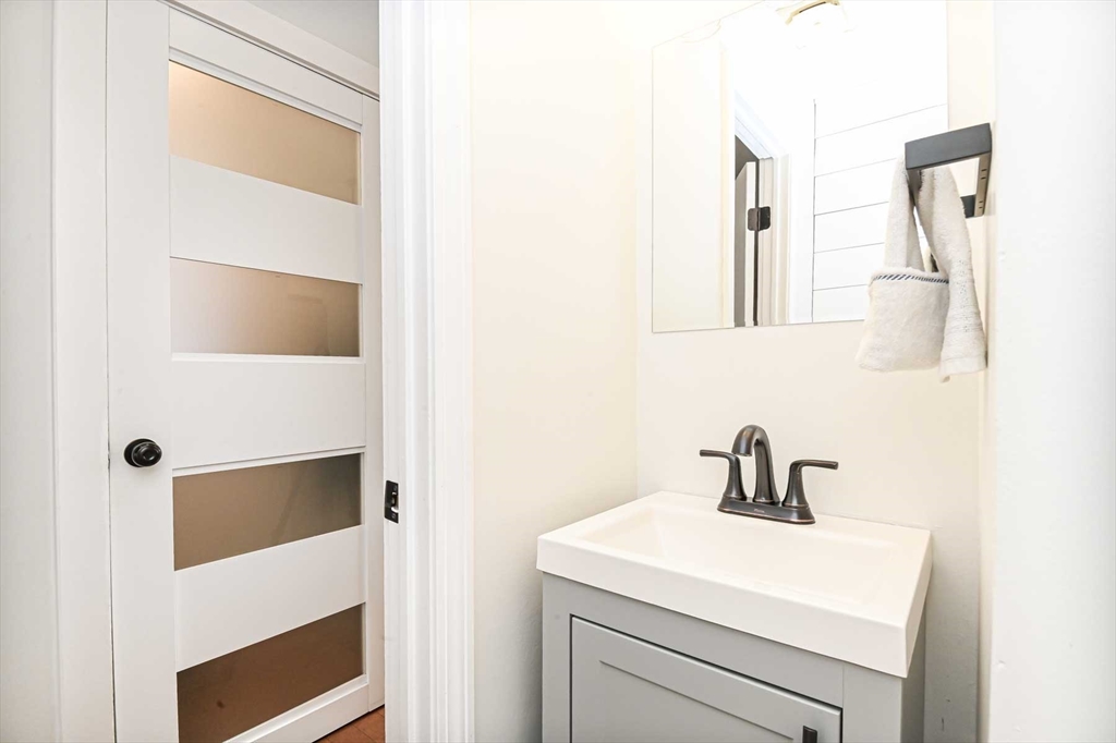 1 Acadia Kimball Road, Unit 1 Amesbury, MA 01913 - Photo 10 of 21 a bathroom with a sink and a mirror