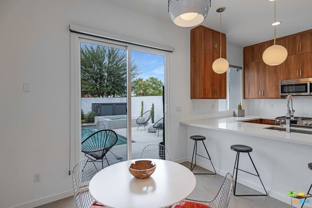504 Paragon Loop Palm Springs, CA 92262 - Photo 12 of 45 a kitchen with a table and chairs in it