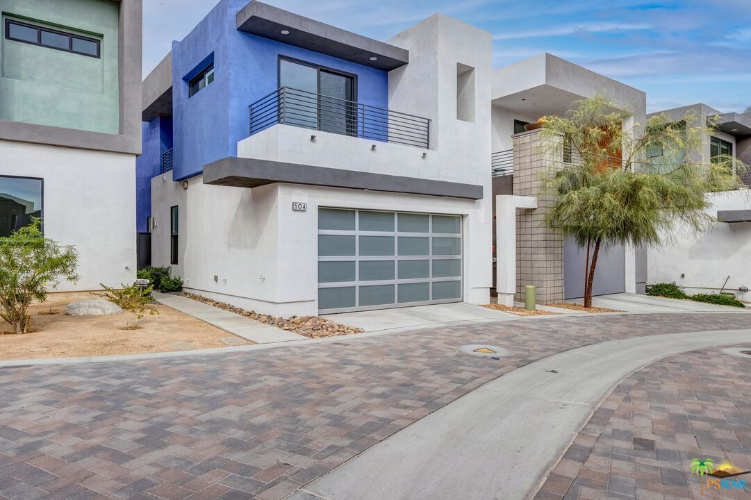 504 Paragon Loop Palm Springs, CA 92262 - Photo 2 of 45 a front view of a house with a yard and garage