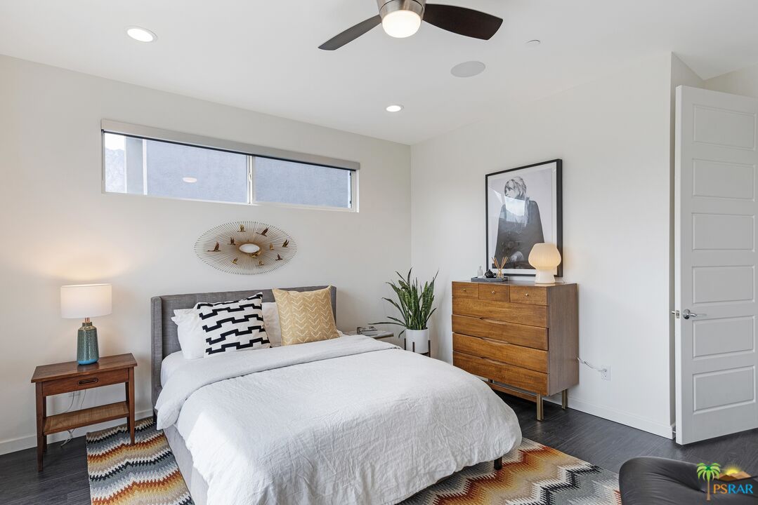 504 Paragon Loop Palm Springs, CA 92262 - Photo 25 of 45 a bedroom with a bed and wooden floor