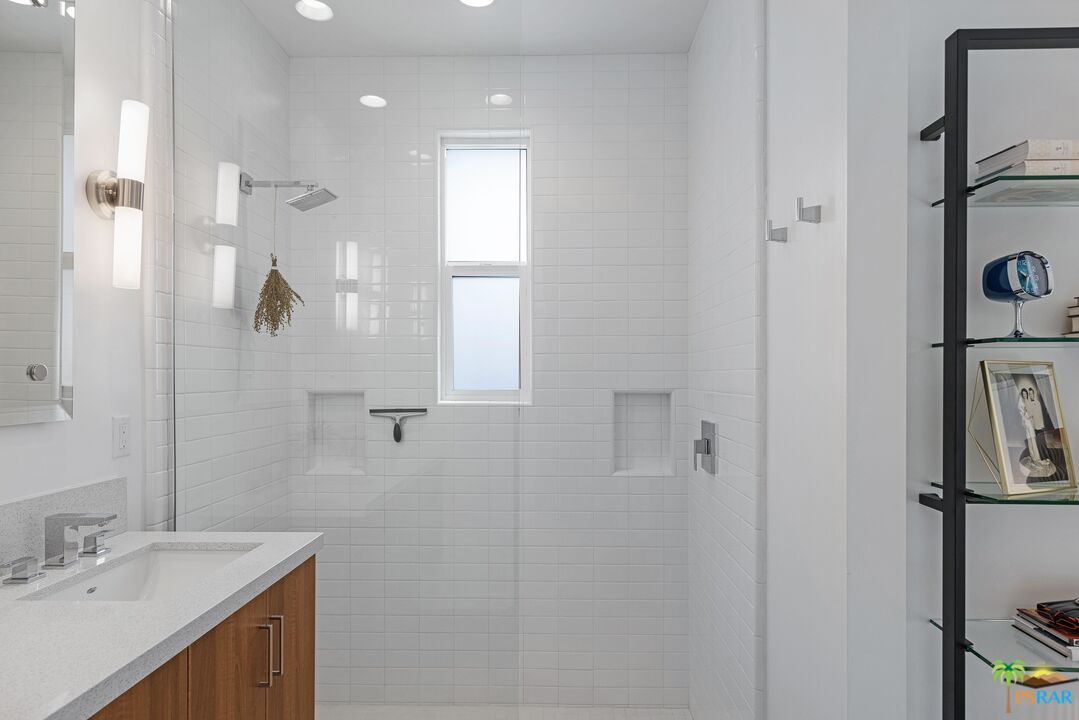 504 Paragon Loop Palm Springs, CA 92262 - Photo 28 of 45 a bathroom with a shower sink and mirror