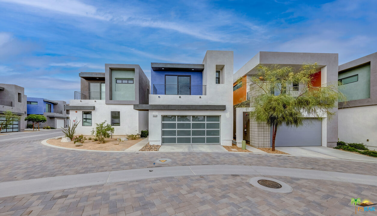 504 Paragon Loop Palm Springs, CA 92262 - Photo 3 of 45 a front view of a house with a yard and garage