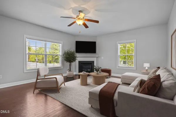 a view of an empty room with a fireplace and a window