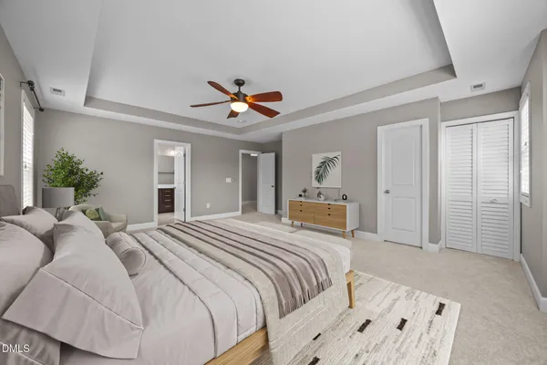 an empty room with windows and fan