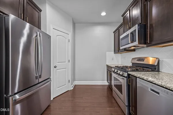 a spacious bathroom with a granite countertop sink a large mirror and a window