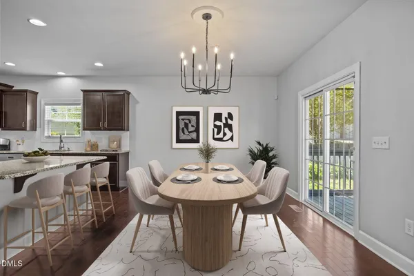 a view of a dining room with furniture wooden floor and chandelier