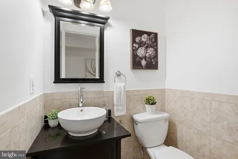 a bathroom with a toilet a sink and mirror
