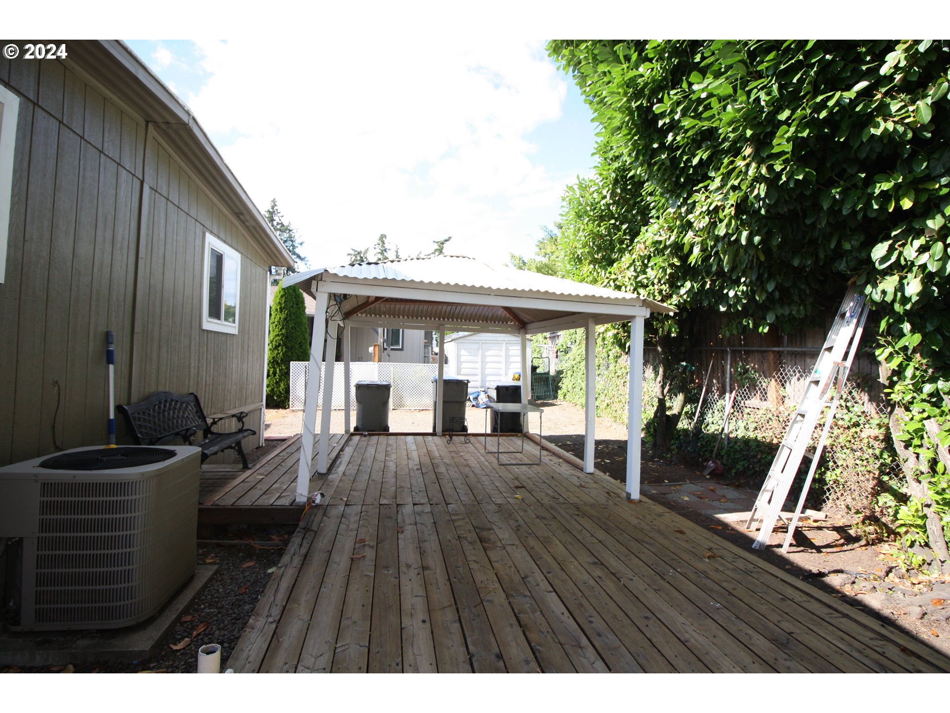 12450 Southwest Fischer Road, Unit 143 Portland, OR 97224 - Photo 2 of 11 a view of a house with backyard and sitting area