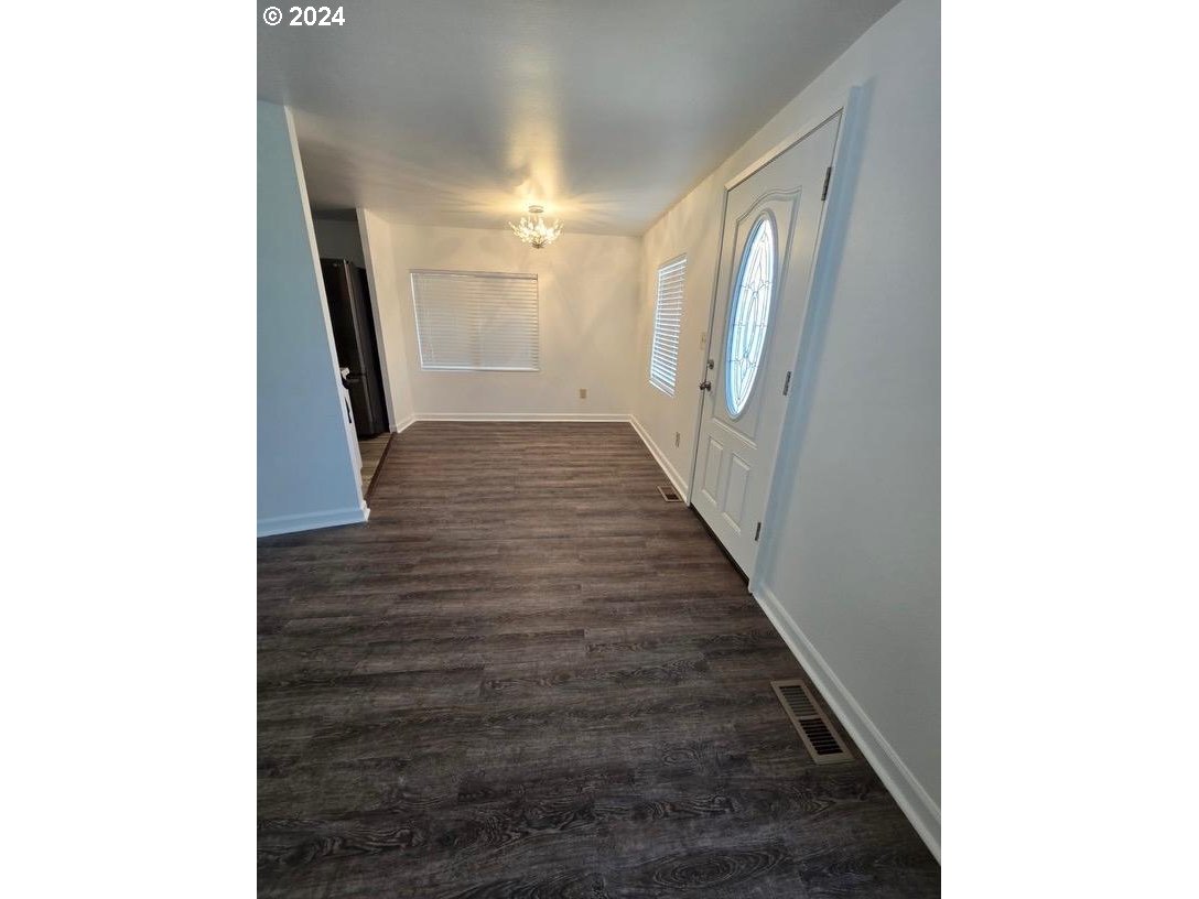 12450 Southwest Fischer Road, Unit 143 Portland, OR 97224 - Photo 10 of 11 a view of a hallway with wooden floor