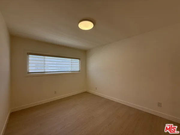 a view of an empty room and closet area