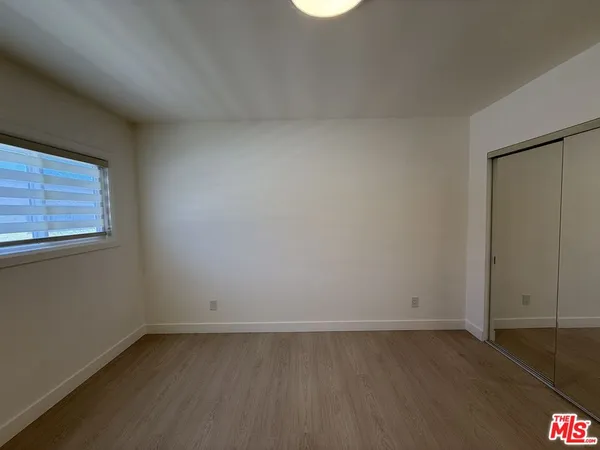 an empty room with closet area