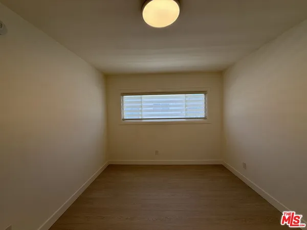 an empty room with a empty space and a window