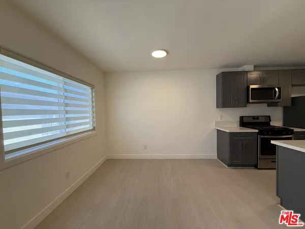 a kitchen with stainless steel appliances a refrigerator and a stove top oven