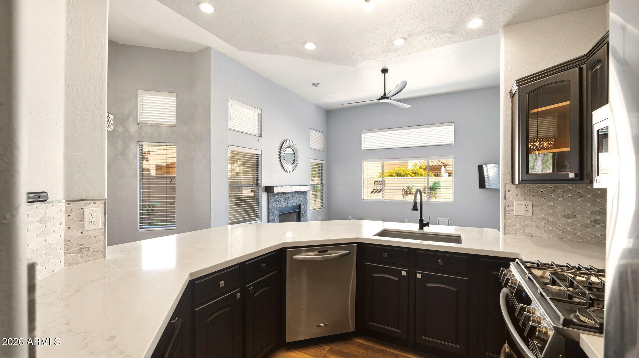 9065 East Gary Road, Unit 126 Scottsdale, AZ 85260 - Photo 11 of 37 a kitchen with a sink stove and cabinets