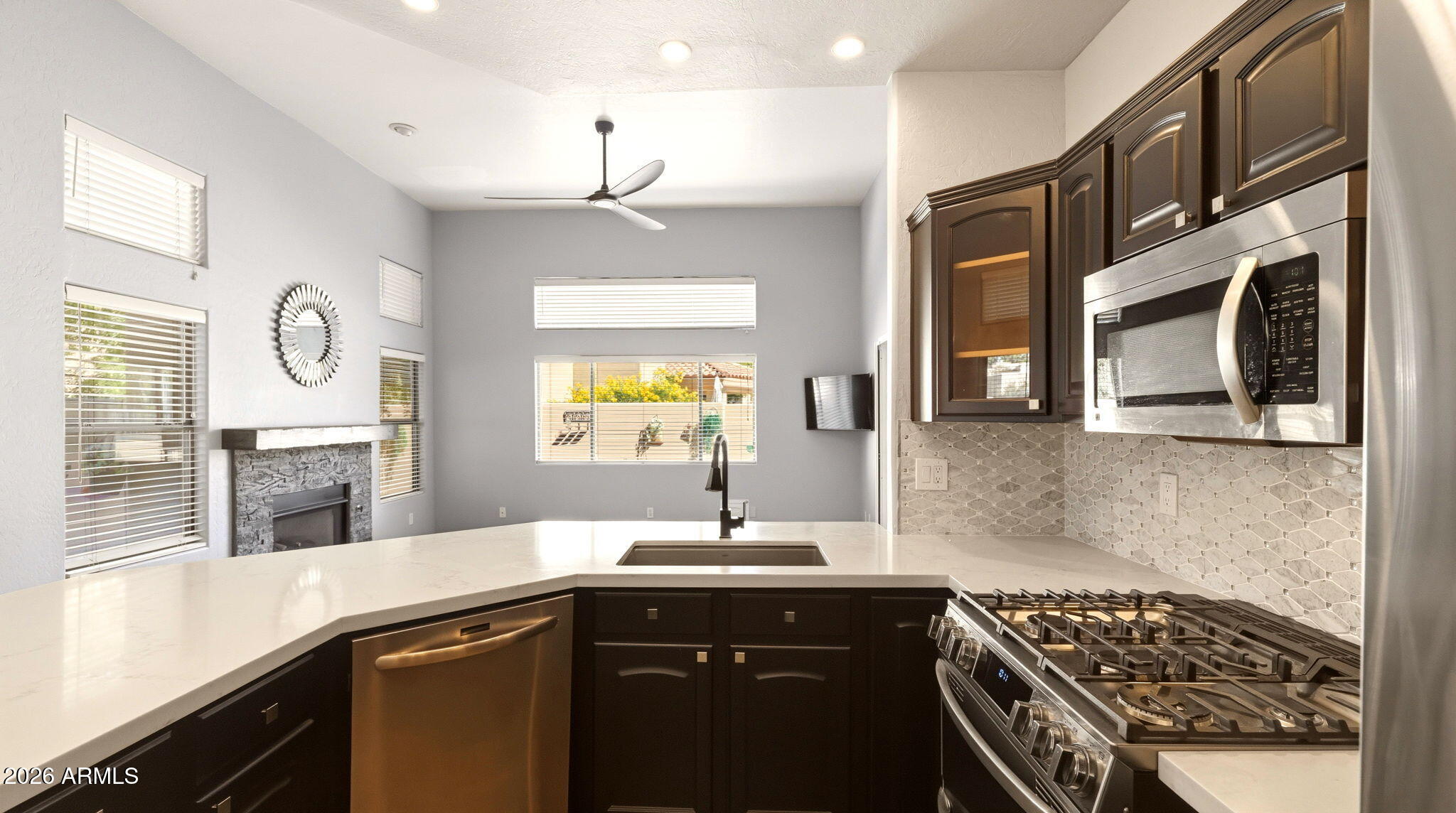 9065 East Gary Road, Unit 126 Scottsdale, AZ 85260 - Photo 12 of 37 a kitchen with a sink a stove and cabinets