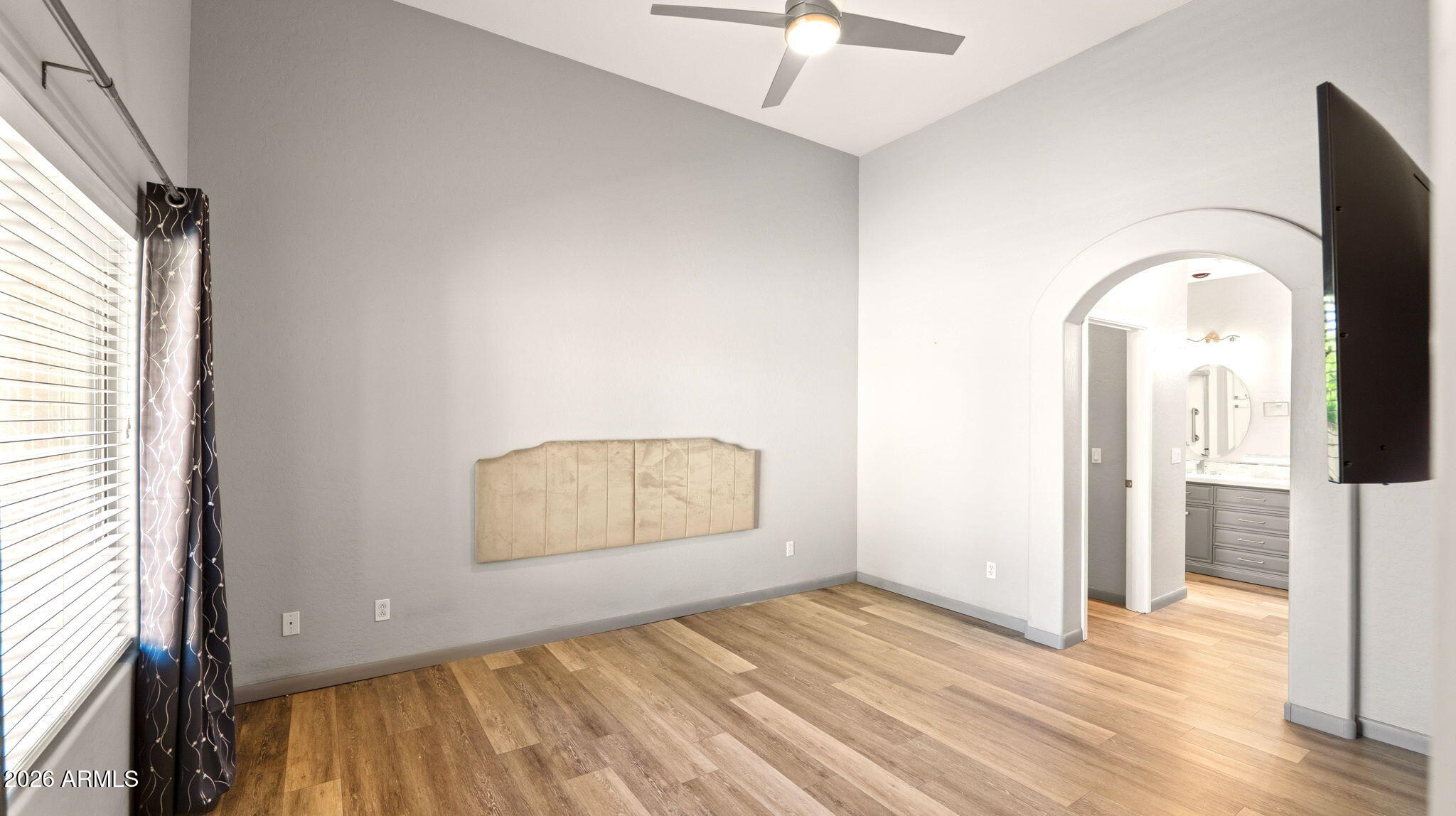 9065 East Gary Road, Unit 126 Scottsdale, AZ 85260 - Photo 15 of 37 a view of empty room with wooden floor and fan
