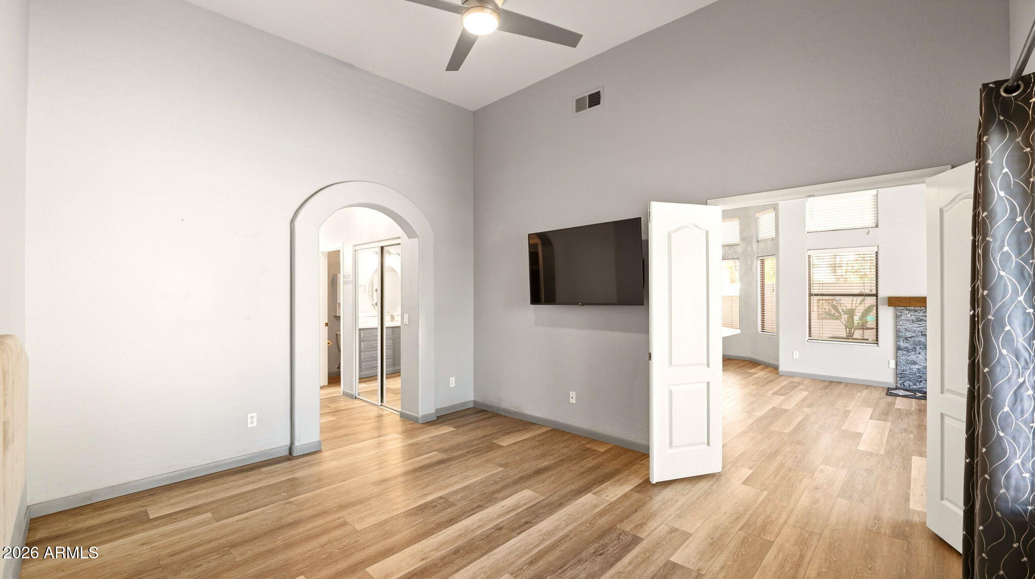9065 East Gary Road, Unit 126 Scottsdale, AZ 85260 - Photo 16 of 37 a view of empty room with wooden floor and fan