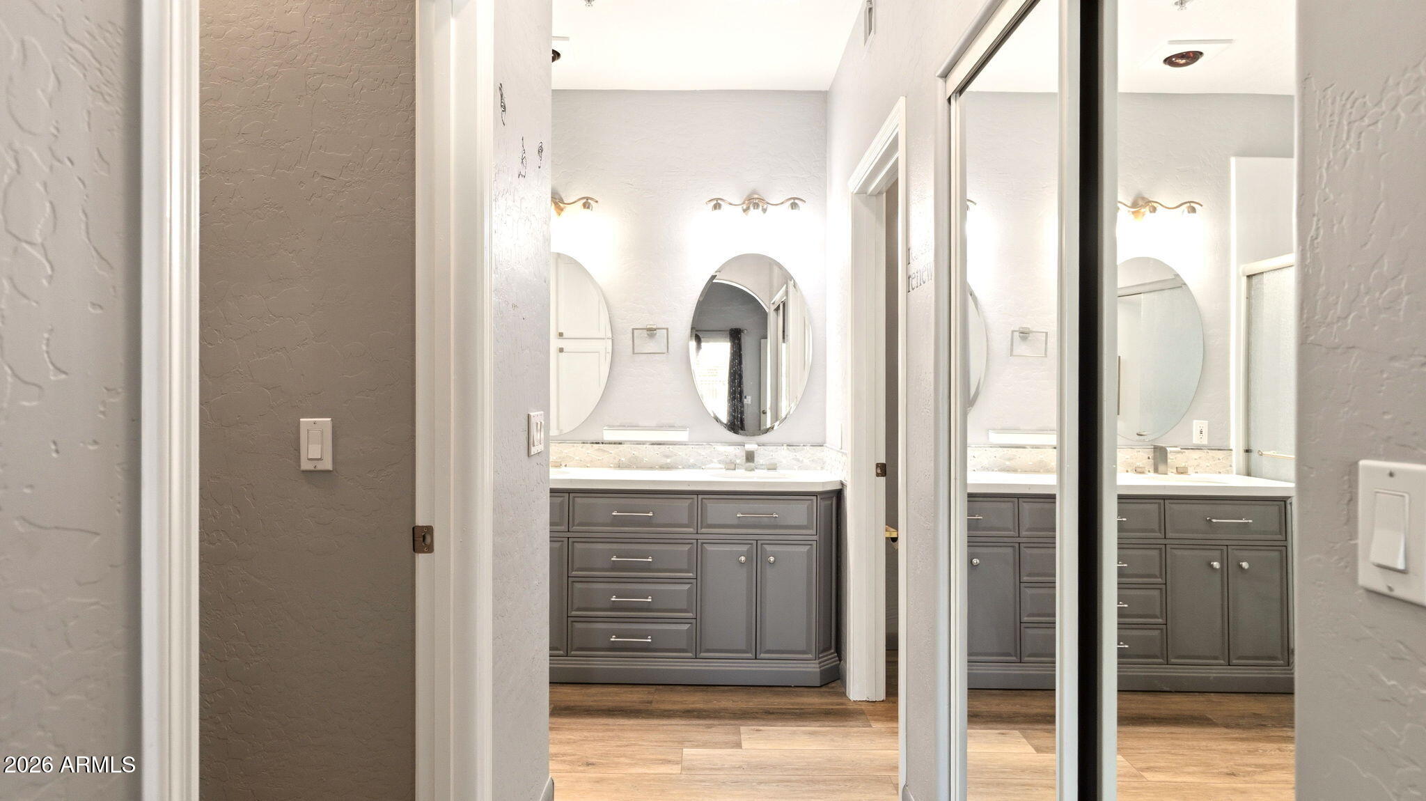 9065 East Gary Road, Unit 126 Scottsdale, AZ 85260 - Photo 18 of 37 a bathroom with a granite countertop sink and a mirror