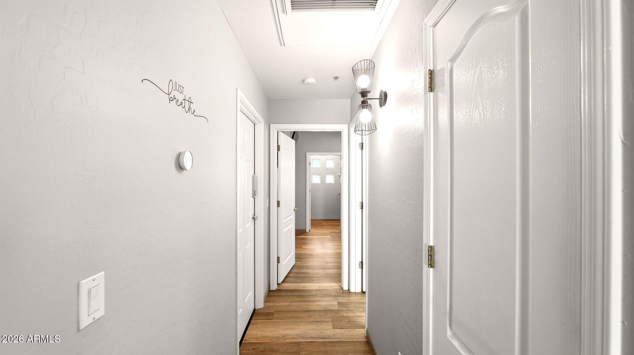 9065 East Gary Road, Unit 126 Scottsdale, AZ 85260 - Photo 22 of 37 a view of a hallway with wooden floor and staircase